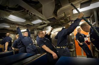 Angles-N-Dangles ~ The Crew Members are not leaning.  The boat is going thru 'Angles & Dangles', and right now it has a down bubble.  Angles & Dangles is designed to check stowage.  Is everything properly stowed?  This is done early (usually the first or second day) in an extended underway period.